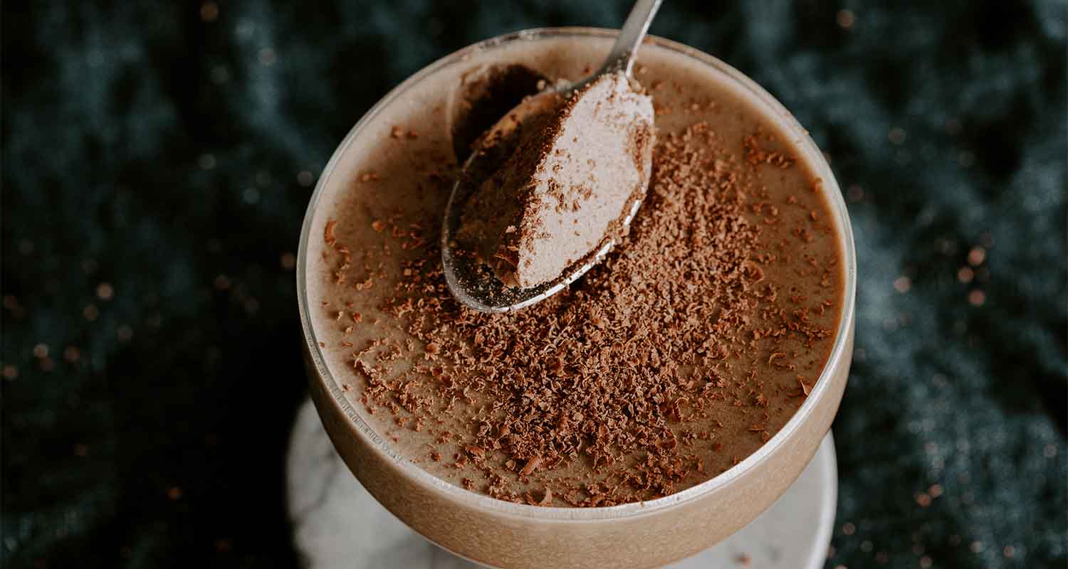 spoon dipping into creamy chocolate panna cotta