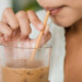 Person sipping iced coffee through a straw