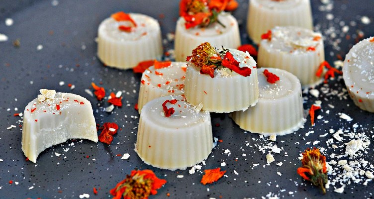 white chocolate bonbons with red floral garnish